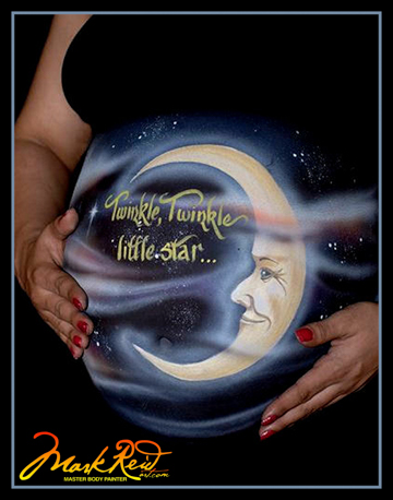 beautiful and whimsical moon painting on a pregnant woman's belly